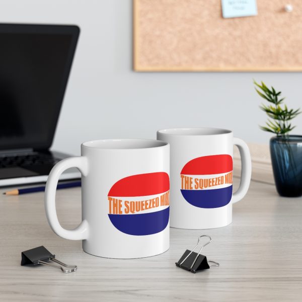 the squeezed middle mug with red and blue bun and words in beige